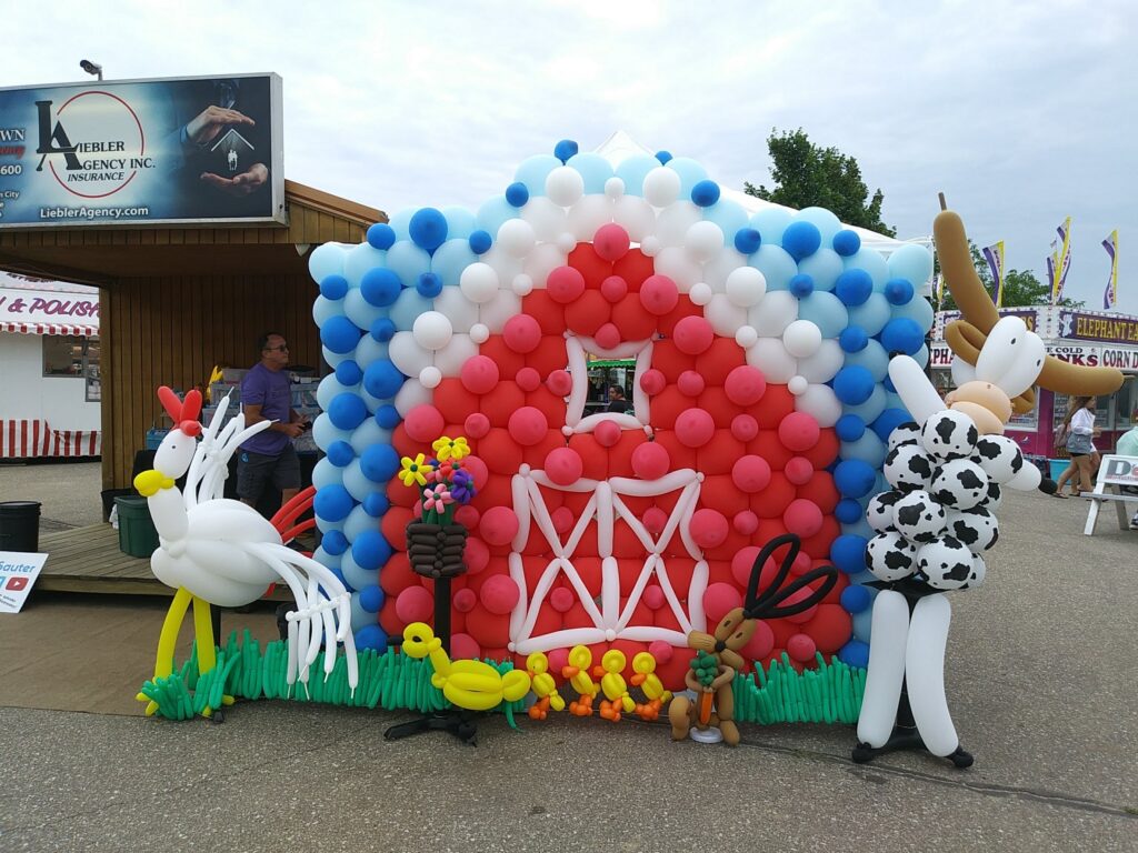 Balloon Sculptures of barn with ranch animals.