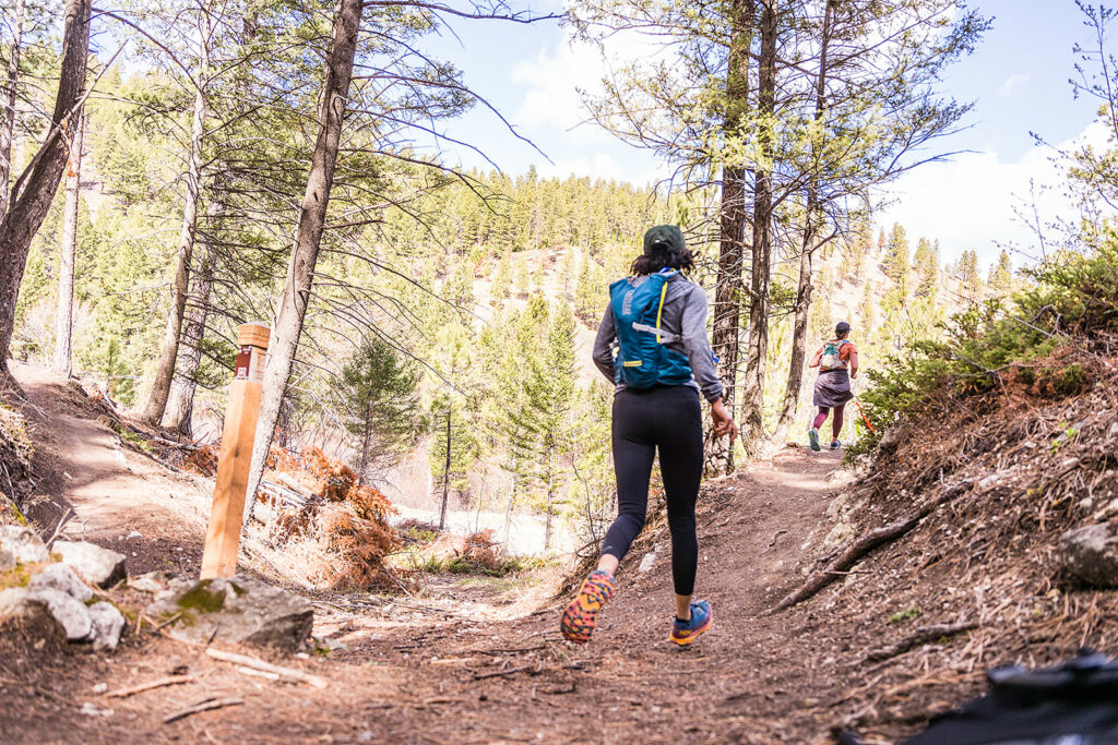 A runner on a trail in the trees.