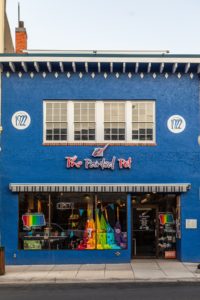 Blue Store Front with sign saying The Painted Pot. A must try family painting experience.